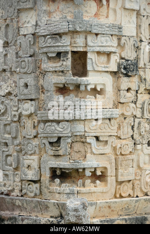 Uxmal, Mexico - 19 Jan 2007:  Two ornately carved  Chaac Rain God heads with missing noses, Casa de las Monjas or The Nunnery Stock Photo