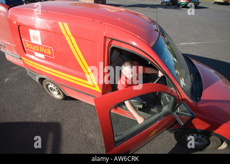 Postman post man working Red tee shirt GPO. Horizontal Narberth Post Office Red van car post bag facing Horizotal sunny blue Sky Stock Photo