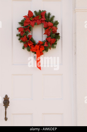 Red and Green Christmas Wreath on White Door, Christmas Holiday Season USA Stock Photo