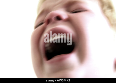 blurred close up of 4 year old boy crying and screaming Stock Photo