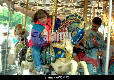 Down syndrome woman age 32 giving thumbs up on carousel. St Paul Minnesota USA Down syndrome woman age 32 giving thumbs up on carousel. St Paul Minnesota USA