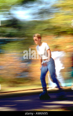 Woman age 21 rollerblading around Lake Harriet. Minneapolis Minnesota USA Stock Photo