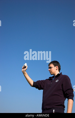 Young man holding digital camera Stock Photo