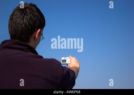 Young man holding digital camera Stock Photo