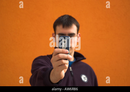 Young man using camera phone Stock Photo