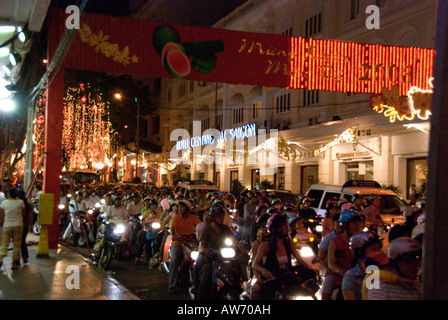 Motorcyclists riding through Ho Chi Minh City in the evening during the Vietnamese New Year 'Tet' celebrations 2008 Stock Photo