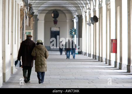 Walkers in Turins colonnades Turin Italy Stock Photo