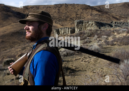 Man upland bird hunting for Alectoris Chukar, Idaho,  (MR). Stock Photo