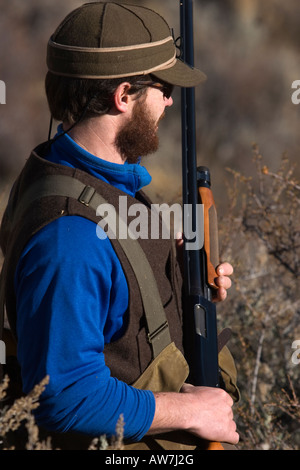 Man upland bird hunting for Alectoris Chukar, Idaho,  (MR). Stock Photo