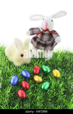 Easter Bunnies and Chocolate Easter Eggs on Grass Stock Photo