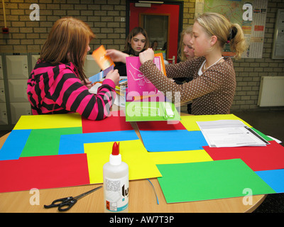 four teenage schoolgirls doing a practical exercise together Stock Photo