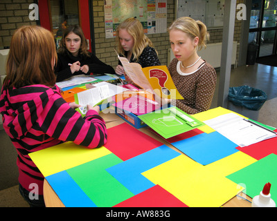 four teenage schoolgirls doing a practical exercise together Stock Photo