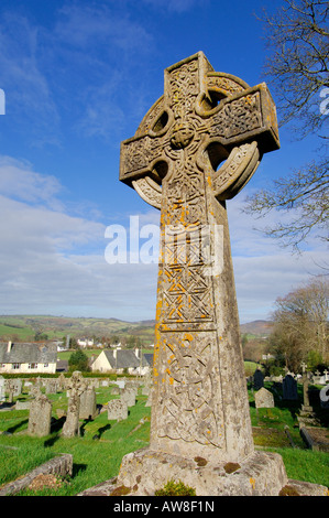 Stone cross with a celtic design in the graveyard of St Michael the Archangel church at Chagford on Dartmoor Stock Photo