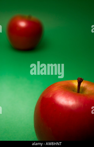 Red Apples on green background Stock Photo