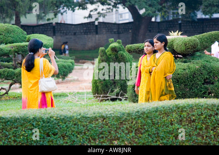 Indian ladies posing for a photograph in the Lalbagh topiary garden Bangalore Stock Photo