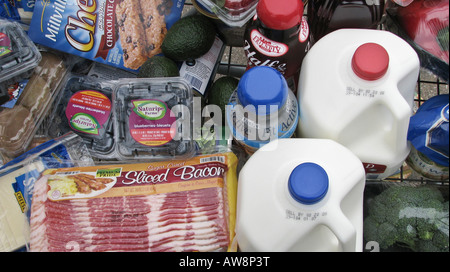 Brown paper bags full of groceries in a shopping wire cart trolley food outside in front of the supermarket overhead nobody horizontal USA US hi-res Stock Photo