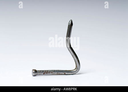 Image of a bent metal nail The photo was taken in the studio against a white background Stock Photo