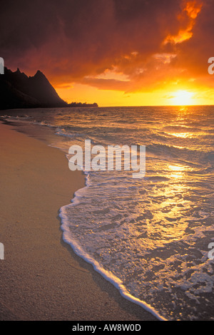 Sunset over surf sand and peaks from Tunnels Beach Haena Island of Kauai Hawaii Stock Photo