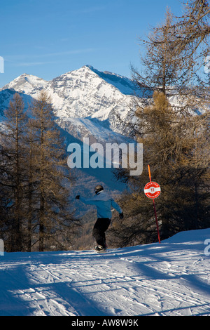 Via Lattea piste marker and skiiers Sportinia Sauze d Oulx Italy Stock Photo