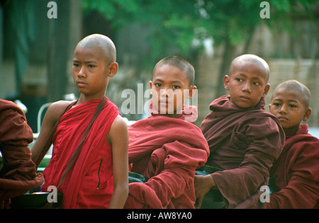 Young monks waiting for alms in the village of Shwe Kyet Yet, near Mandalay, Myanmar (Burma) Stock Photo