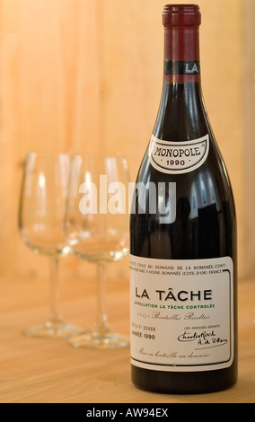 Single Bottle La Tache Monopole, a very expensive French Wine with wine glasses Stock Photo