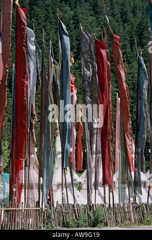 Prayer flags flutter outside a Buddhist monastery in Jaizagu National Park, China Stock Photo