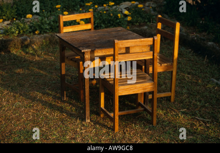 Table & chairs in sunlight at Samthar Farmhouse, Samthar Plateau, hills of West Bengal, India Stock Photo