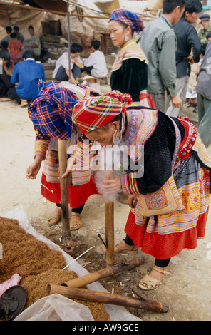 Women smoking pipes at Bac Ha market, Northern Vietnam Stock Photo