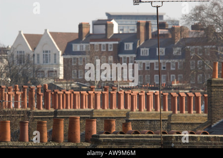 Chimney pots and television aerials in the foreground of a London skyline. Stock Photo