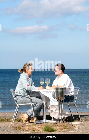 A couple eating with sea view Normandy France Stock Photo