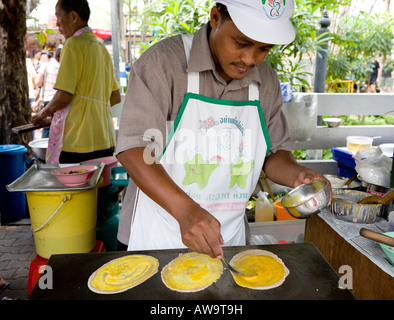 Thai Man preparing Local Food In A Bangkok Street Market Thailand South East Asia Stock Photo