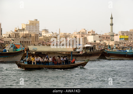 Ferry boat passengers sitting on an abra, being ferried across the Creek in Dubai, UAE. Between Deira and Bur Dubai. Stock Photo