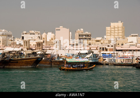 Deira shown from the Creek in Dubai, UAE. With small passenger ferry boats - abras, and the medium-sized freight carrying boats. Stock Photo