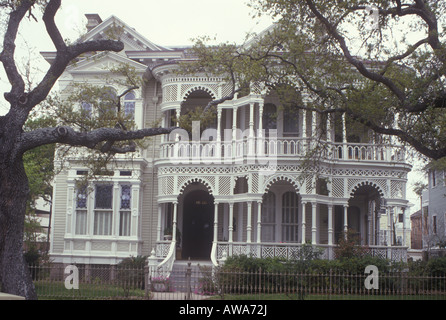 American Victorian mansion in Galveston Texas. Timber frame with elaborate gingerbread turned wood decoration on double porch. Stock Photo