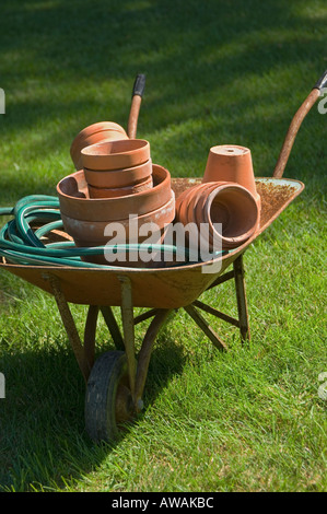 Wheelbarrow and gardening tools Stock Photo