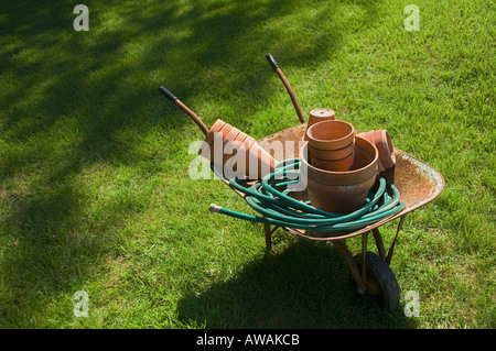 Still life of wheelbarrow and gardening tools Stock Photo