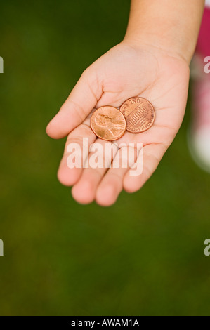 Closeup of pennies in childs palm Stock Photo
