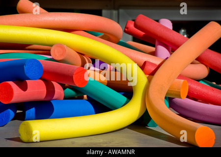 Coloful foam rubber swimming pool floats lie in a bright tangle Stock Photo