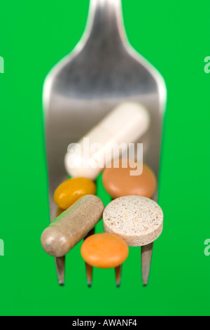 Various Pills on a Fork Stock Photo