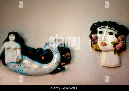 ceramic wall hanging of Greek faces and mermaids, Chania local art and craft gallery, Crete, Greece Stock Photo