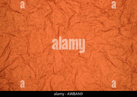 ABSTRACT RANDOM BACKGROUND OF CREASED CRUMPLED ORANGE RED TISSUE PAPER Stock Photo