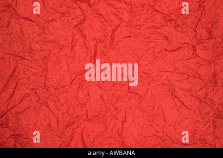 ABSTRACT RANDOM BACKGROUND OF CREASED CRUMPLED BRIGHT RED TISSUE PAPER Stock Photo