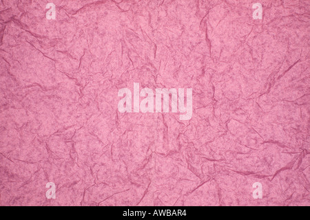 ABSTRACT RANDOM BACKGROUND OF CREASED CRUMPLED PALE PINK TISSUE PAPER Stock Photo