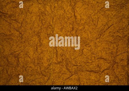 ABSTRACT RANDOM BACKGROUND OF CREASED CRUMPLED DARK ORANGE TISSUE PAPER Stock Photo