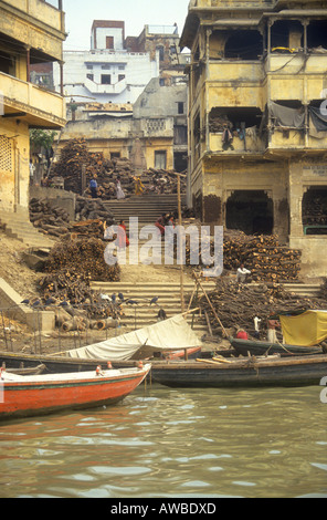 The burning Ghats where cremations take place on the banks of the sacred river Ganges at Varanasi India Stock Photo
