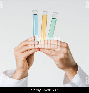 Hand holding test tubes Stock Photo