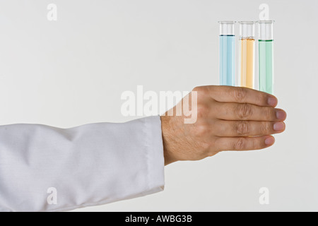 Hand holding test tubes Stock Photo