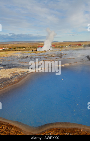 Strokkur geyser spouts hot water to a height of some 100 feet Iceland ...