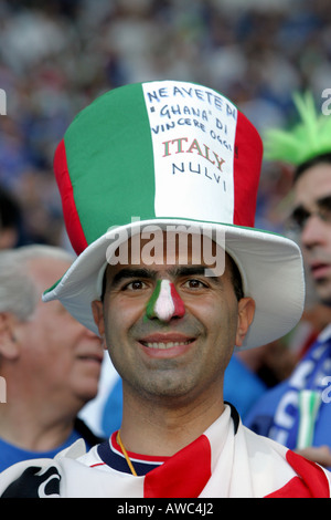 An Italian supporter with a painted nose and wearing a hat in the crowd during the 2006 World Cup Stock Photo