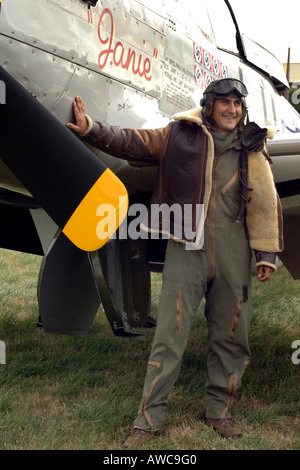 WWII Aircrew posing by a P 51 Mustang Fighter Plane on display at an Airshow Stock Photo